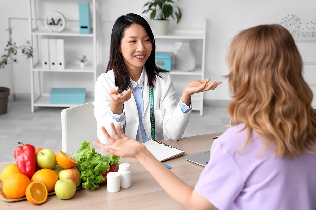 A nutritionist working with a client in an office